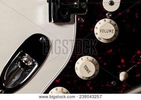 Close-up Of Electric Guitar Volume And Tone Control Knobs. Classic Vintage Controls In Cream And Gol