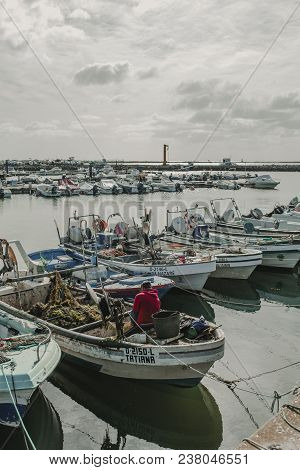 March 24th, 2018 - Olhao, Portugal: Fisherman Working And Repairfisherman Working And Repairing Nets