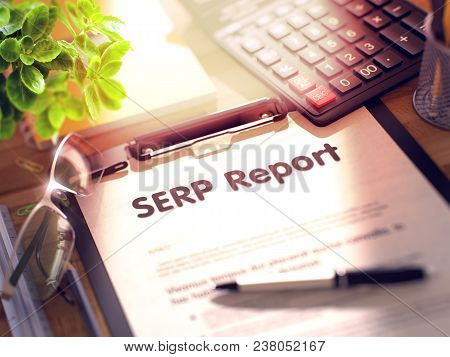 Serp Report On Clipboard. Wooden Office Desk With A Lot Of Business And Office Supplies On It. 3d Re