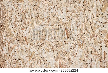 Fiberboard. Compressed Light Brown Wooden Plywood Texture. Close Up Surface Of Pressed Wood-shaving 