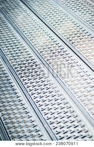Metal Structures In A Warehouse In Stacks. Metal Supports For Scaffolding And Formwork. Soft Focus A