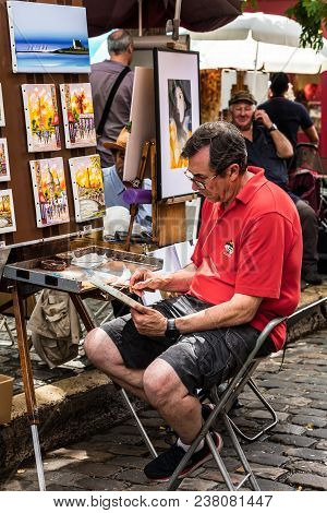 Paris, France - July 06, 2017: The Painter Works At The Open Air Artist Market At The Tertre Square 