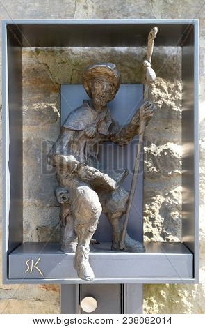 LEUTERSHAUSEN, GERMANY - JULY 05: Statue of pilgrims to Santiago de Compostela by Sieger Koder in front of Church of Saint Bartholomew in Leutershausen, Germany on July 05, 2017.