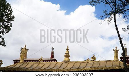 Brass Statue On The Roof With Sky