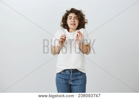 Disgusted Worried Curly-haired Female, Grimacing From Negative Emotions, Bending Backwards And Raisi
