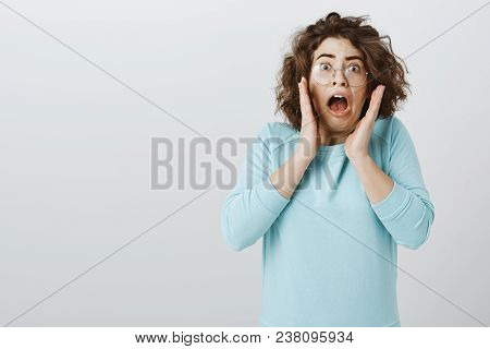 Oy My Gosh, It Is Disgusting. Studio Portrait Of Shocked And Terrified Attractive Curly-haired Brune