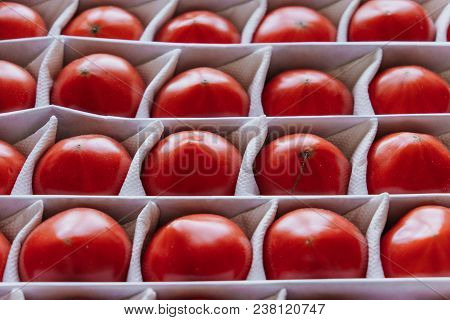 Ripe Tomatoes In A Box, Fruits Lie Separately.