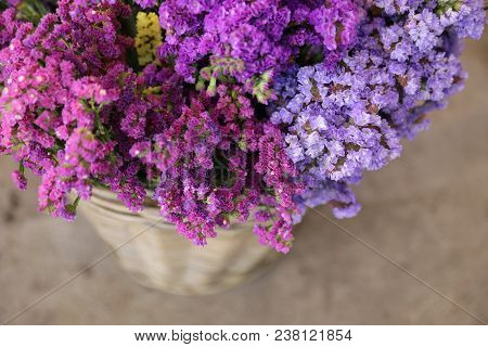 In A Wicker Basket Variety Of Limonium Sinuatum Or Statice Salem Flowers In Pink, Lilac, Violet Colo