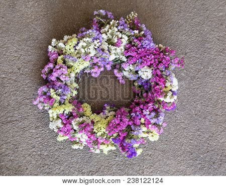 Wreath Decoration On The House Door Of Limonium Sinuatum Or Statice Salem Flowers In Blue, Lilac, Vi