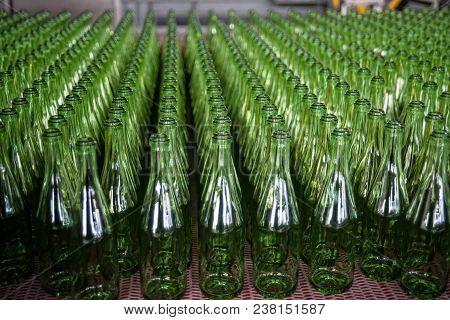 Many Bottles On Conveyor Belt In Glass Factory