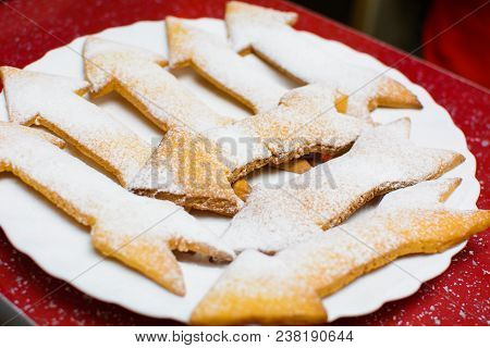 Many Cookies In The Form Of Arrows On A Plate.