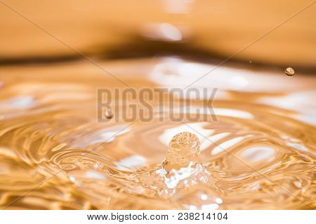 Shining Drop Of Water Colored Of Orange Isolated Composition