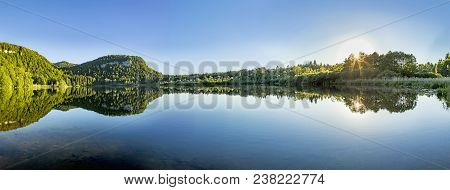 Scenic Reflection Of Forest In The Clear Lake At Bonlieu