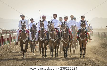 Men Arriving At A Horse Race In A Countryside Of Oman