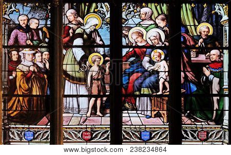 PARIS, FRANCE - JANUARY 04, 2018: St. John the Baptist introduced by his mother, St. Elizabeth, the Infant Jesus and the Holy Kinship, stained glass window in Saint Severin church in Paris, France.