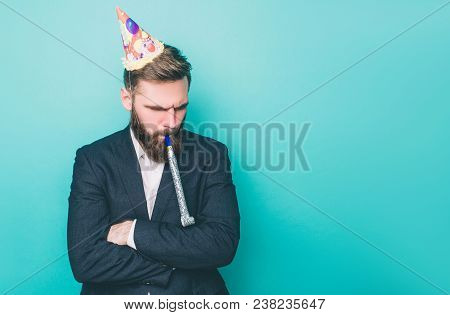 Sad Guy Is Standing And Looking Down. He Is Upset. Man Is Holding A Wistle In His Mouth And Has A Bi