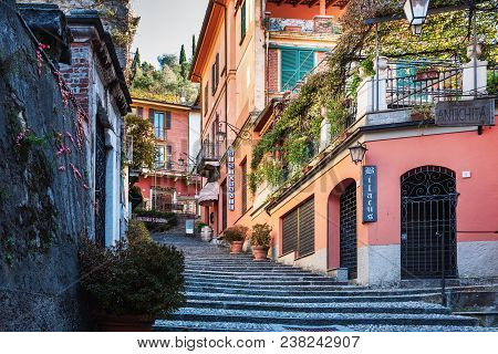 Bellagio, Italy - December 2017: Narrow Street With Pebble Road And Color Houses At Historical Part 
