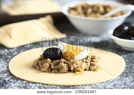 Preparing Traditional Chilean Empanada De Pino, Stuffed With Ground Beef, Onion, Black Olive, Raisin