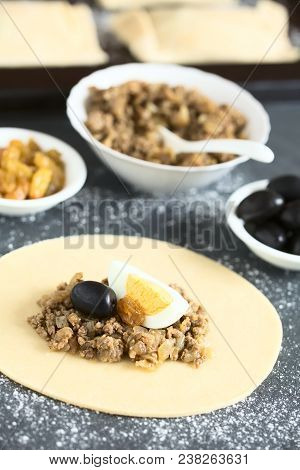 Preparing Traditional Chilean Empanada De Pino, Stuffed With Ground Beef, Onion, Black Olive, Raisin