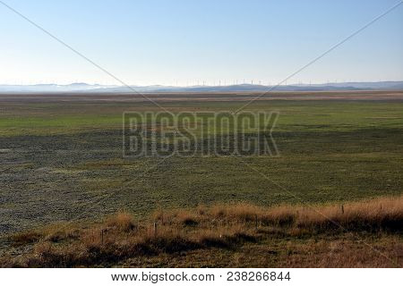 Empty Lake George Nestled Between A Rural Wind Farm And Farmland In Australia. Lake George Is An End