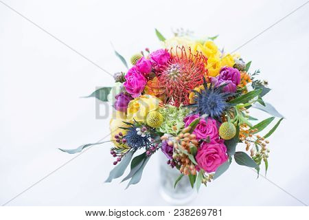 Colorful Bouquet Of Yellow, Coral And Rose Roses, Blue Eringium, Red Leucospermum, Orange Asclepia, 