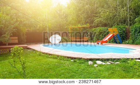 Pool In The Backyard With A Slide. Holiday House With Swimming Pool. Resort House