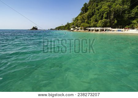 Scenic Sea View Of The Kapas Island At Terengganu, Malaysia. Clear Sea Water And Blue Sky Background