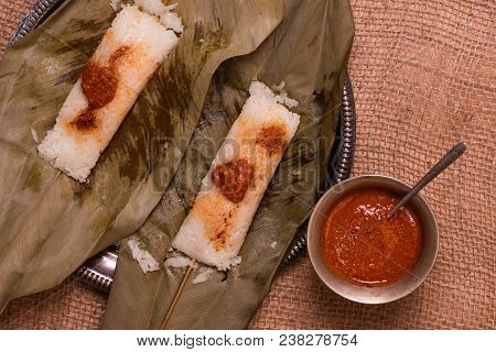 Top View Of Open Sticky Rice Wrapped In Leaves And Served With Peanut Sauce. Famous Cuisine In Borne