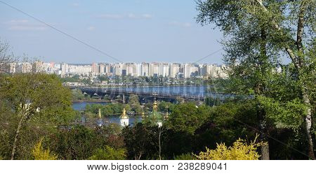 View Of The Dnieper, The Paton Bridge And The Left Bank Of Kiev On A Sunny Spring Day. Botanical Gar