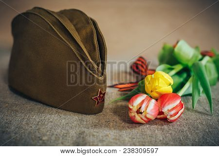 Military Cap With Order Of Great Patriotic War And Tulips Flowers Tied By Saint George Ribbon In Hon