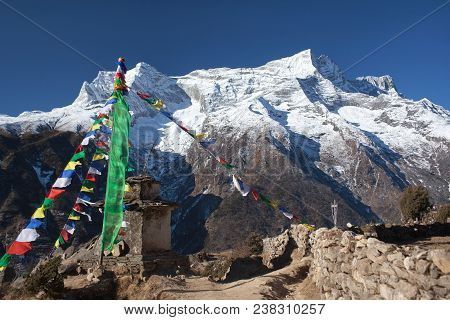 Panoramic View Of Kangtega And Thamserku Peaks And Ancient Stone Chorten Above Namche Bazaar In Saga
