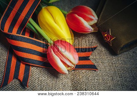 Military Cap With Order Of Great Patriotic War And Tulips Flowers Tied By Saint George Ribbon In Hon