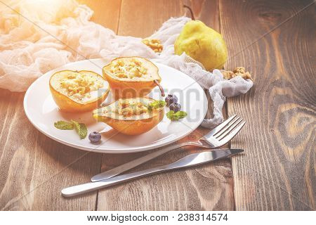 Pears Baked With Ricotta Cheese, Nuts, Honey And Cinnamon On Rustic Wooden Background