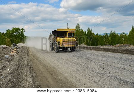 Belaz Truck Transports Ore On A Dirt Road