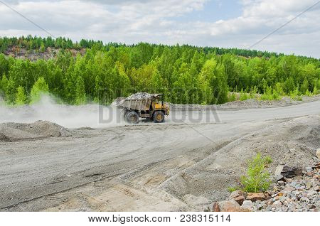 Belaz Truck Transports Ore On A Dirt Road