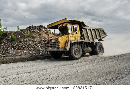 Belaz Truck Transports Ore On A Dirt Road