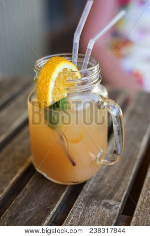 Refreshing Fruit Cocktail With A Tube In A Glass On Wooden Table