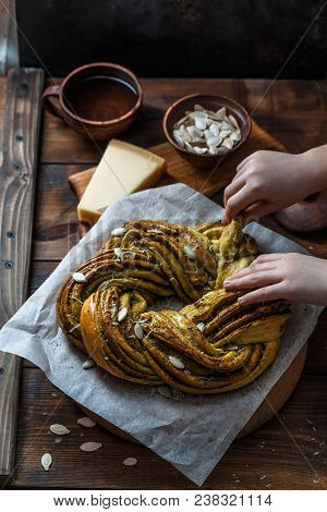 Babka Brioche Wreath With Pesto And Parmesan With Hands.