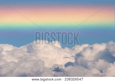 Bright Rainbow Close-up. Seven-color Full Spectrum. Photo Superimposed Cumulus Fluffy Cloudy On A Sk