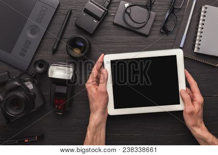 Photographer Using Blank Digital Tablet On Workplace With Photo Equipment, Scrolling Photos, Technol