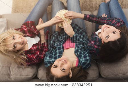 Three Women Eating Popcorn And Looking Up At Home, Female Friends Having Rest After Hard Week, Top V