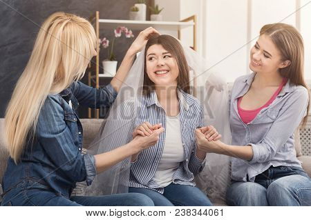 Girl Preparing For Wedding And Showing Bridal Veil To Her Friends. Celebration, Henparty Before Wedd