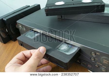 Videocassette Is Put Into The Video Recorder To Watch The Video, Another Video Cassette Is On The Vi