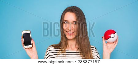 Ufa, Russia - July 8, 2017: Woman Holding Pokeball With Pikachu. Pokemon Go Multiplayer Game