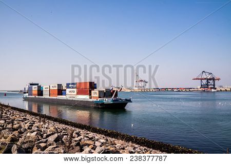Rotterdam , Netherlands - April 20 2018 : Large Harbor Cranes Loading Container Ships In The Port Of