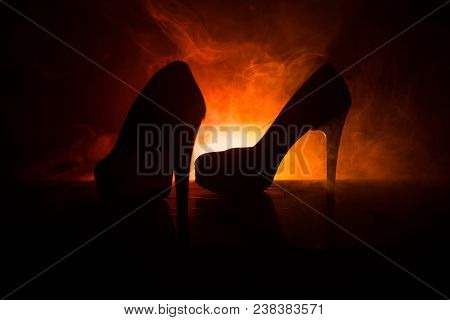 Black Suede High Heel Women Shoes On Dark Toned Foggy Background. Close Up. Women Power Or Women Dom
