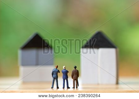 Miniature Businessmen Standing Investment Analysis Housing Or Investment In Movable Property. Using 