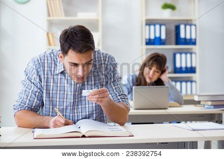 Students sitting and studying in classroom college