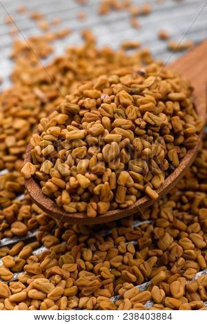 Fragrant Grains Of Fenugreek On A Rustic Background.