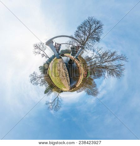 Green Little Tiny Planet With Trees Near Gateway Lock Sluice Construction On River, White Clouds And